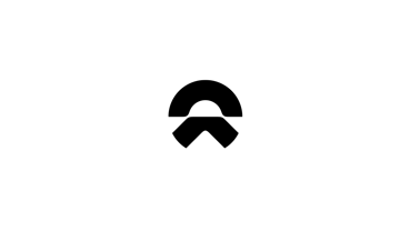 Sort kat sidder i en vindueskarm og kigger ud med den ene pote hvilende på kanten. Sollyset strømmer ind gennem vinduet.